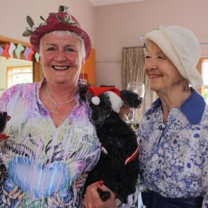 Janet-Pikovance-toasts-the-season-with-her-poodle-Caramea-and-Margaret-Kingston.jpg